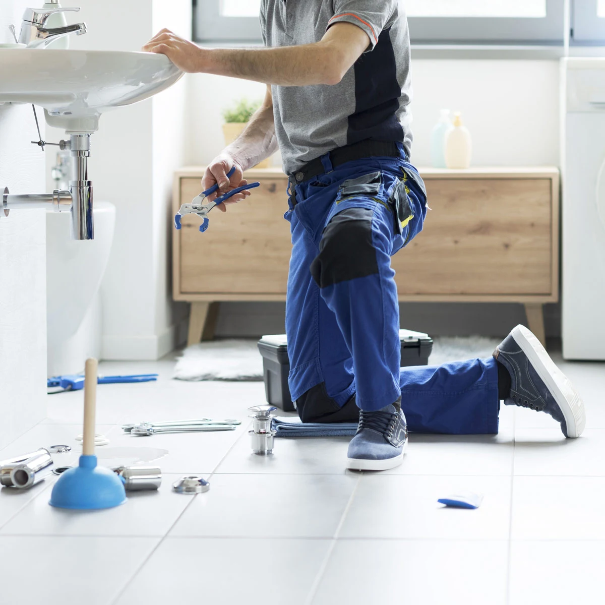 Plumber servicing sink