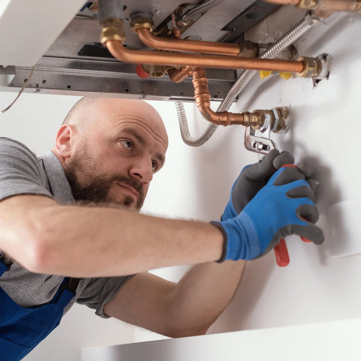 Plumber working on boiler